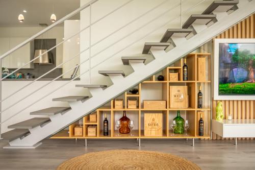a staircase with a shelf of wine bottles at Villa 65 - City Edge Retreat in Funchal