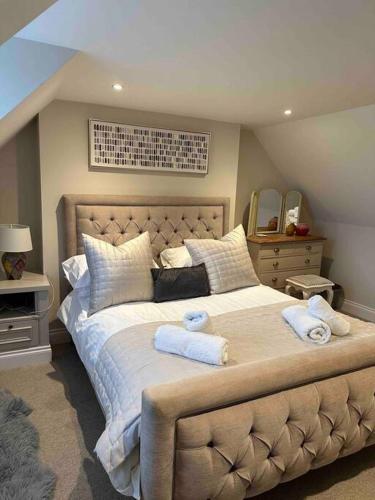 a bedroom with a large bed with towels on it at Prior House Farm in Berwick-Upon-Tweed