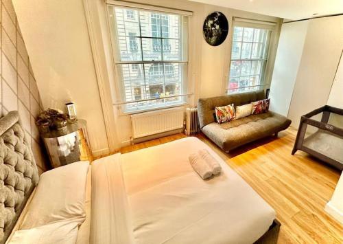 a living room with a bed and a couch at Haymarket 2: Large Central Apt! in London