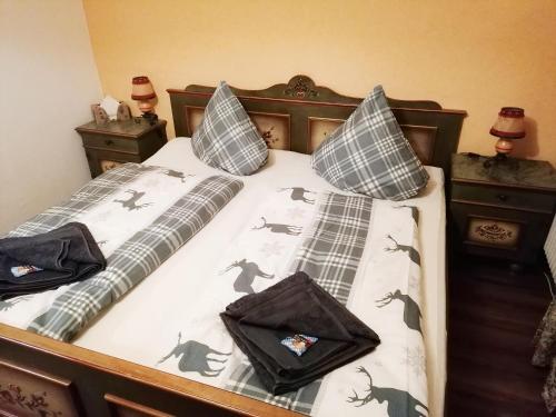 a bed with black dinosaur pillows on it at Auszeitstube - Chiemgau Karte in Inzell