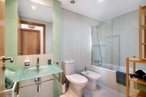 a bathroom with a toilet and a sink at Tavira Mar in Cabanas de Tavira