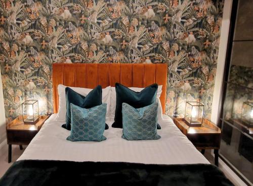 a bedroom with a bed with pillows and a wallpaper at The Academy House by Bevolve in Shrewsbury