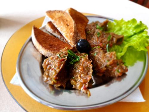 a plate of food with a sandwich and lettuce at Hotel Perfect in Yamna