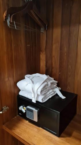 a pile of white towels sitting on top of a microwave at Winner Inn in Yangon