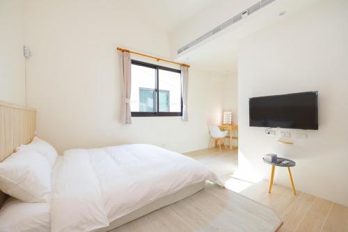 Ένα ή περισσότερα κρεβάτια σε δωμάτιο στο Vision旺民宿