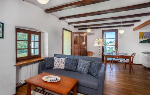 a living room with a blue couch and a table at Lovely Apartment In Bribir in Bribir