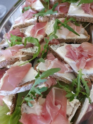 a plate of sandwiches with meat and cheese at Hotel Perfect in Yamna