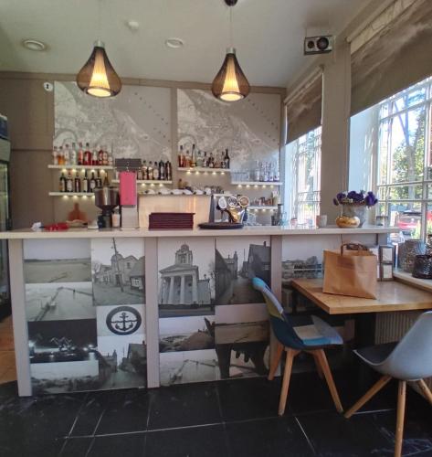 a restaurant with a counter and a table and chairs at Jūras Brīze in Ventspils