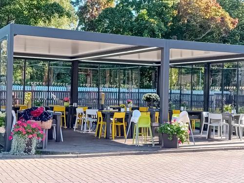 a group of tables and chairs in a pavilion at Jūras Brīze in Ventspils