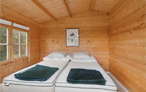 a large bed in a wooden room with a bed at 3 Bedroom Beautiful Home In Sams in Tanderup