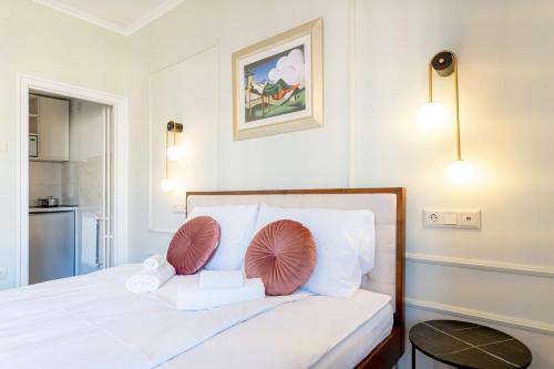 a bedroom with a bed with two pillows on it at Újbuda Rest Apartment With Air Condition and Balcony in Budapest