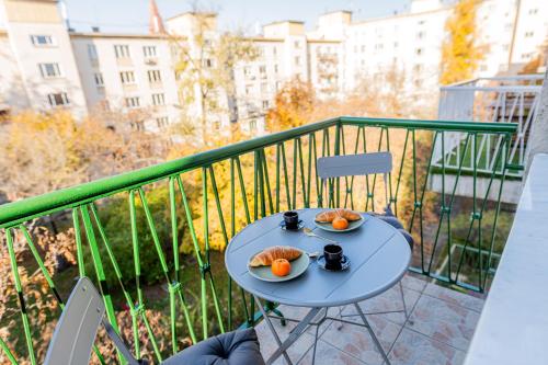a table with two plates of oranges on a balcony at Újbuda Rest Apartment With Air Condition and Balcony in Budapest