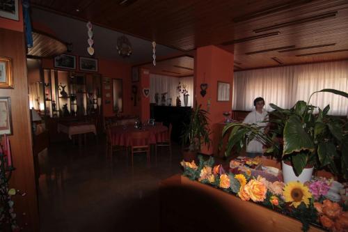 a man sitting at a table in a restaurant at Albergo Trieste in Tambre dʼAlpago