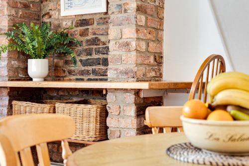 a bowl of fruit on a table in a room at Gamul Place - Quiet City Centre in Chester