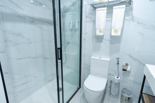 a white bathroom with a toilet and a shower at Hotel BH San Francisco Alicante in Alicante