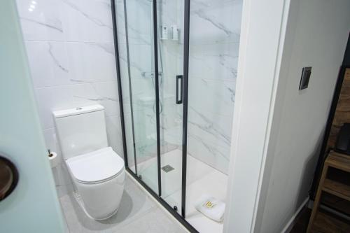 a bathroom with a toilet and a glass shower at Hotel BH San Francisco Alicante in Alicante