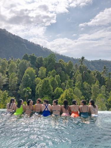 a group of women are standing in the water at Munduk Kupang Sekumpul Villa in Singaraja
