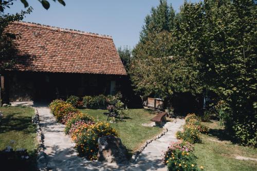 a garden with flowers in front of a building at Magaze de Luxe in Gradačac
