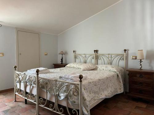 a bedroom with a bed with a metal frame at Villa Felici in Giuliano di Roma