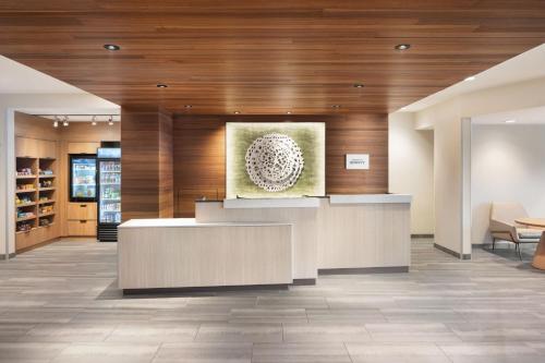 a lobby with a reception desk in a building at Fairfield Inn & Suites by Marriott West Kelowna in West Kelowna