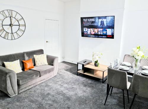 a living room with a couch and a table at Burnley Terraced House by BEVOLVE - Free Parking 3 in Burnley