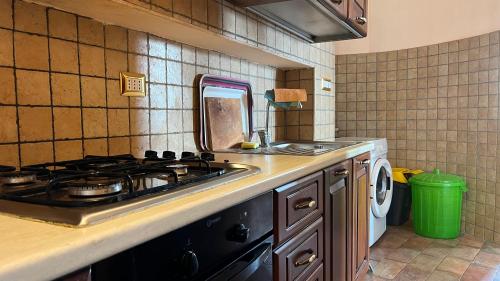a kitchen with a stove and a sink at Villa Felici in Giuliano di Roma