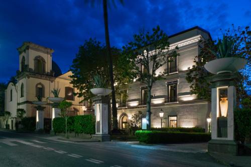 a large white building on a street at night at Grand Hotel Cocumella in Sant'Agnello
