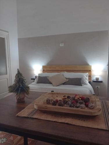 a bed with a tray of fruit on a table at AREMU in Lecce