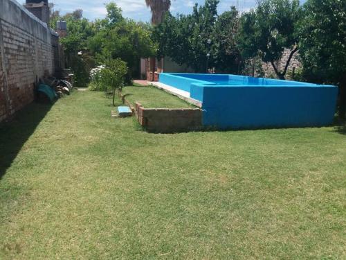 a large blue swimming pool in a yard at Casa en la Ruta del Vino in Mendoza