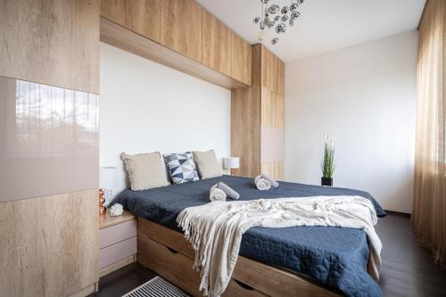 a bedroom with a bed with a large window at Premier Pest Side Apartment in Budapest