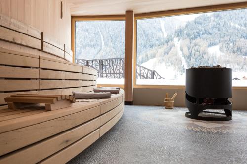 a room with a fireplace and a large window at SILENA, your soulful hotel - adults only in Valles