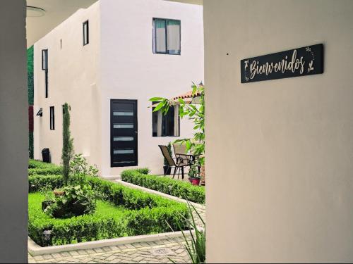 a house with a sign on the side of it at Hotel Bungalows Casa Blanca in Tenancingo de Degollado