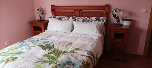a bedroom with a bed and two night stands at La belleza del Tietar in Lanzahita