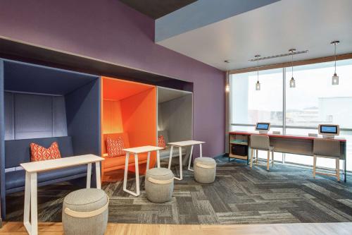 a room with desks and a table and a desk at Tru By Hilton Jacksonville St Johns Town Center in Jacksonville