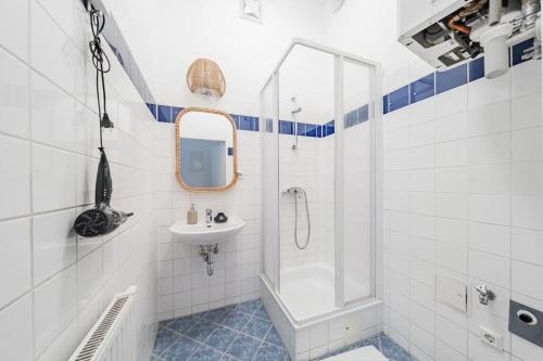 a white bathroom with a sink and a shower at City Chic #18 in Vienna