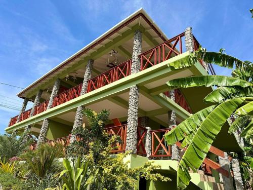 a building with a red balcony on top of it at ORCHID RESORT Ltd in Guillet