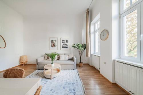 a white living room with a couch and a table at City Chic #18 in Vienna