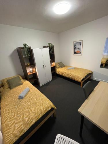 ヘールレンにあるRoom With Two Beds in Centrumのベッド2台と白いキャビネットが備わる客室です。