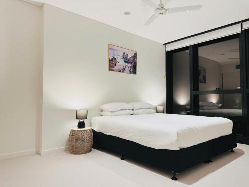 Habitación blanca con cama y ventana en Skyscape Spectacle 3Bedrooms Panorama Views, en Brisbane