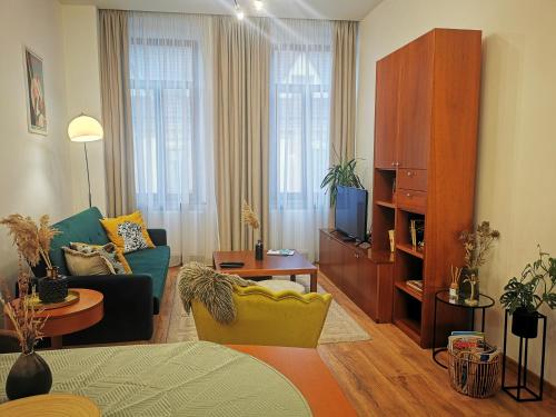 a living room with a couch and a tv at Atlas Apartment in the historical center of Košice with free private parking in Košice