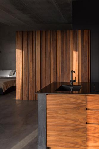a bathroom with a black sink and a bed at Buahjar Boutique Home Apartment in Agrigento