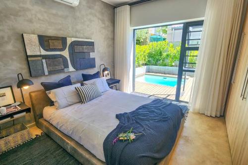 a bedroom with a large bed and a swimming pool at House of Anjel in Suider-Paarl