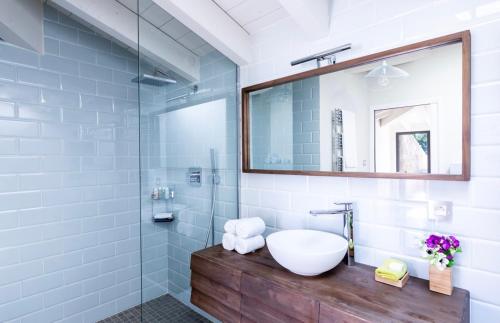 a bathroom with a sink and a mirror at The Beach House in Olmeto