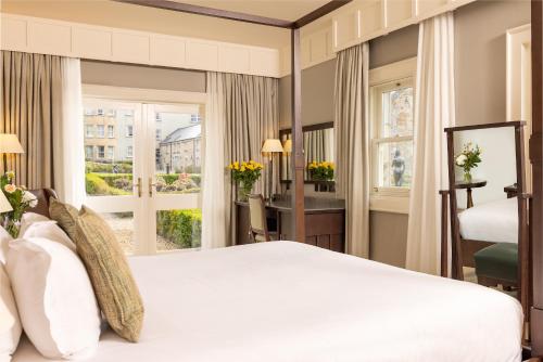 a hotel room with a bed and a window at Lough Eske Castle in Donegal