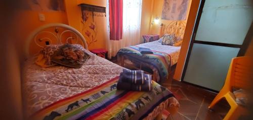 Łóżko lub łóżka w pokoju w obiekcie Hostal Golden Quinua