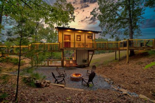 a house with a fire pit in the yard at Cozy Treehouse w Hot Tub, Fire Pit, Pet Friendly, Lake Access in Morganton