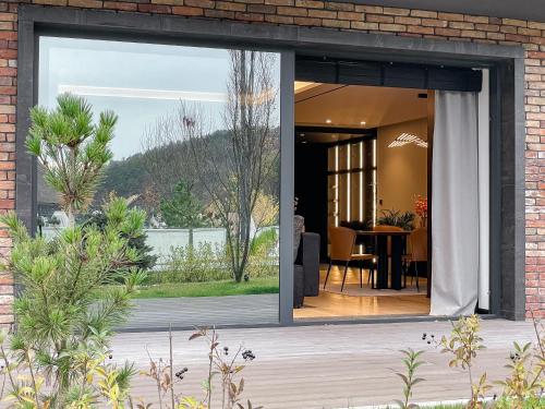 a sliding glass door leading to a patio with a table at Emily Resort in Lviv