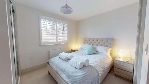 a bedroom with a bed with towels on it at Little Lane in Wantage