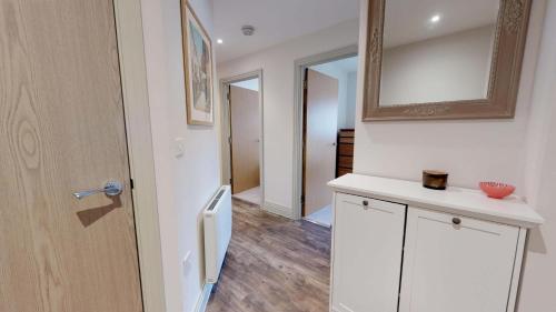 a kitchen with a white refrigerator and a mirror at Little Lane in Wantage