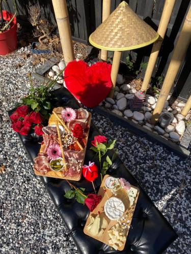 a table with presents and flowers and a lamp at Loveroom intimiste et haut de gamme à 30 min de Toulouse in Lagrâce-Dieu